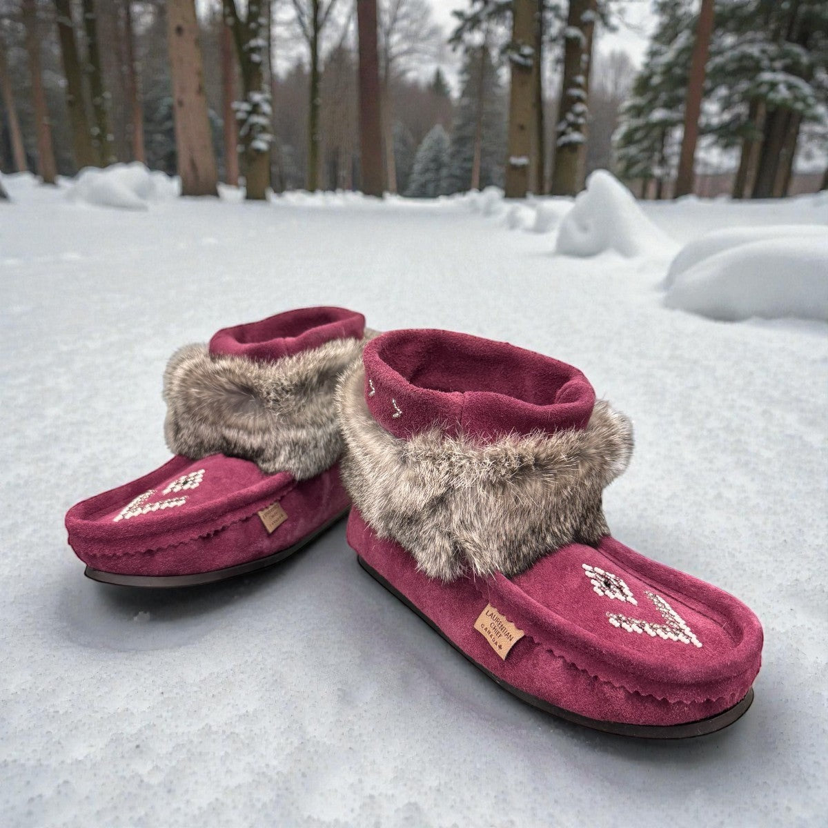 Laurentian Chief Nuka bordeaux suede moccasin with fur trim, beaded details, and black crepe sole.