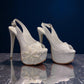 NIKPA ALEX white patent leather slingback platform heel with pearl and sequin floral embellishment