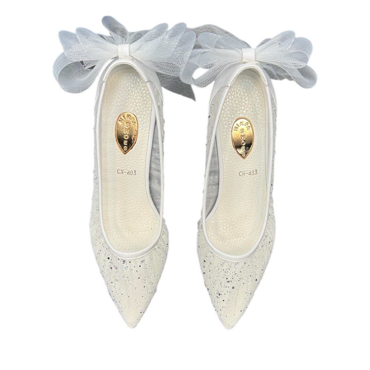 NIKPA SANA white bridal pump with glitter finish, pointed toe, and sheer tulle bow detail on the heel.