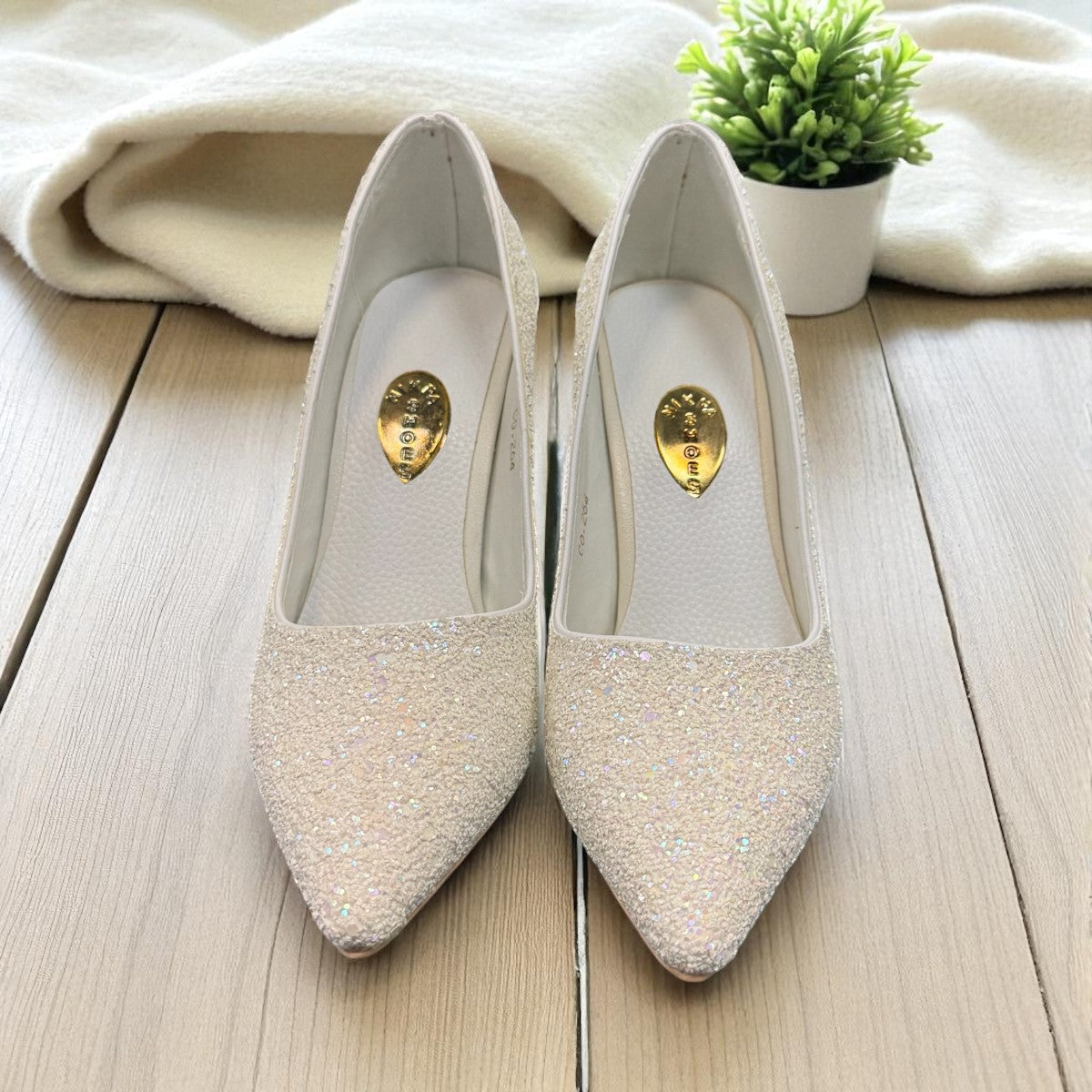NIKPA SHIMA white glitter bridal stiletto heels with a pointed toe for party and wedding wear