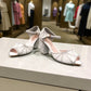 Nikpa lalala white synthetic bridal heels with intricate rhinestone detailing and an ankle strap in a ballroom