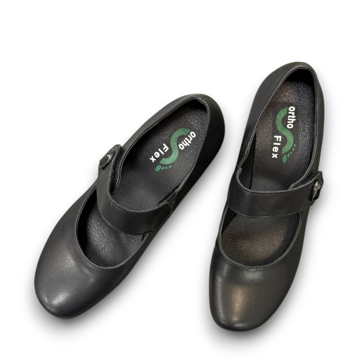 ORTHO-FLEX-F7108L black genuine leather Mary Jane shoe with an adjustable strap, metallic accent, and block heel.
photo of the top side