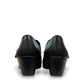 ORTHO-FLEX-F7108L black genuine leather Mary Jane shoe with an adjustable strap, metallic accent, and block heel.
photo of the back side