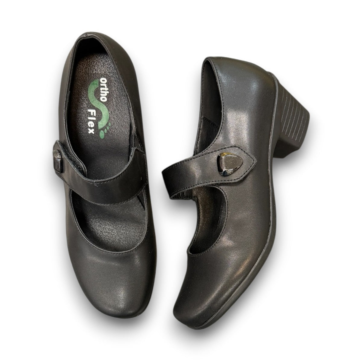 ORTHO-FLEX-F7108L black genuine leather Mary Jane shoe with an adjustable strap, metallic accent, and block heel.
photo of the top side