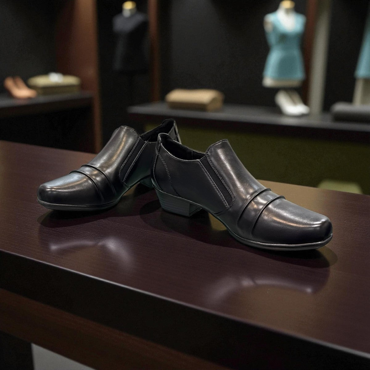 Ortho Flex black low-cut dress shoe with side zipper detail and a short block heel.
photo of the front side