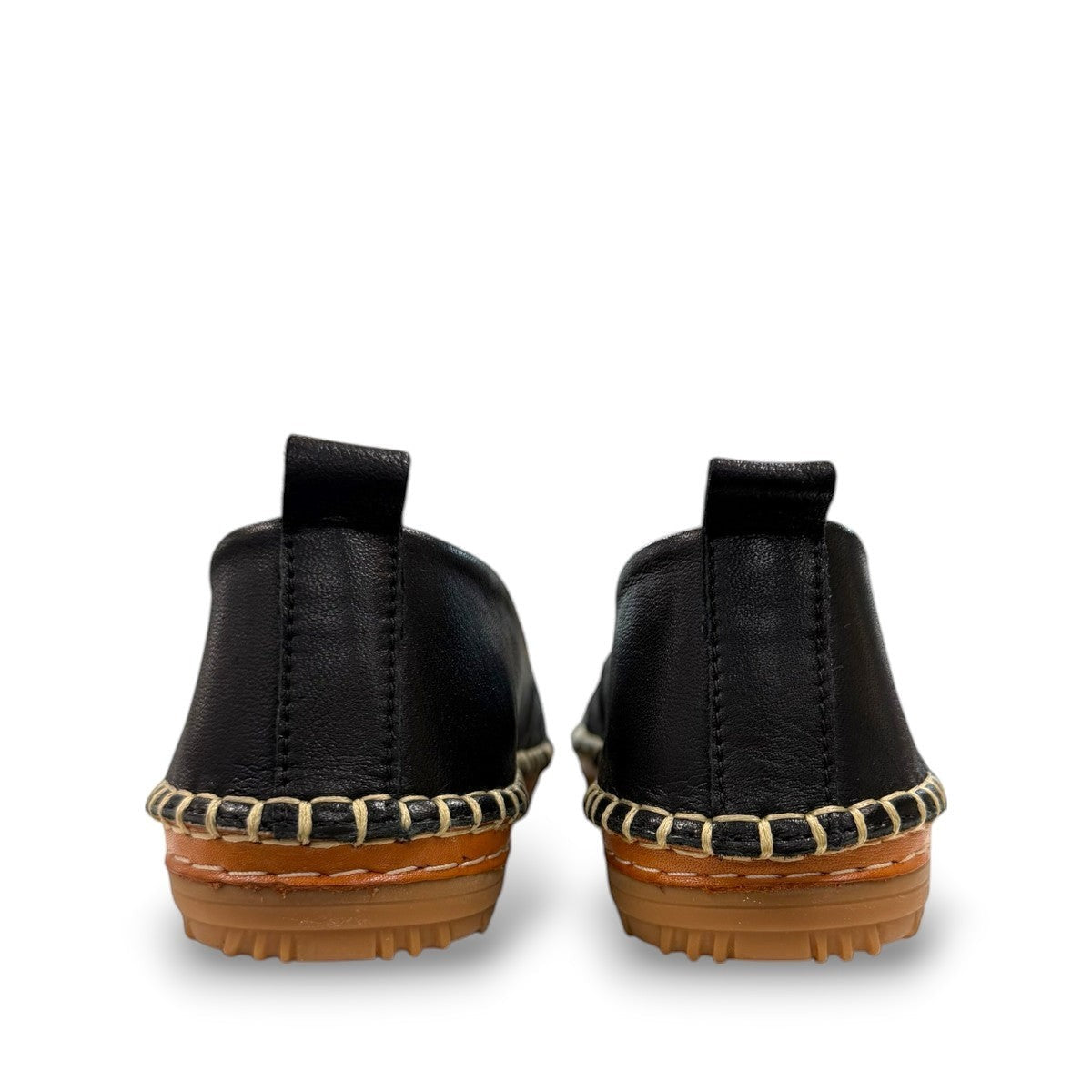 Roamers Avery black leather flat with decorative whipstitch detailing and a durable rubber sole.
photo of the back side