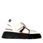 roamers white leather platform sandals with adjustable straps and a chunky black treaded sole.
photo of the right side