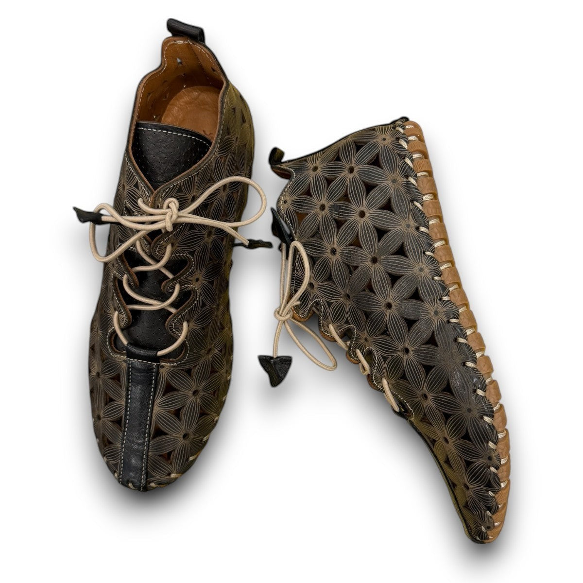 Roamers Venus black leather ankle boots with decorative floral cutouts, elastic lacing, and flat sole.
photo of the top side
