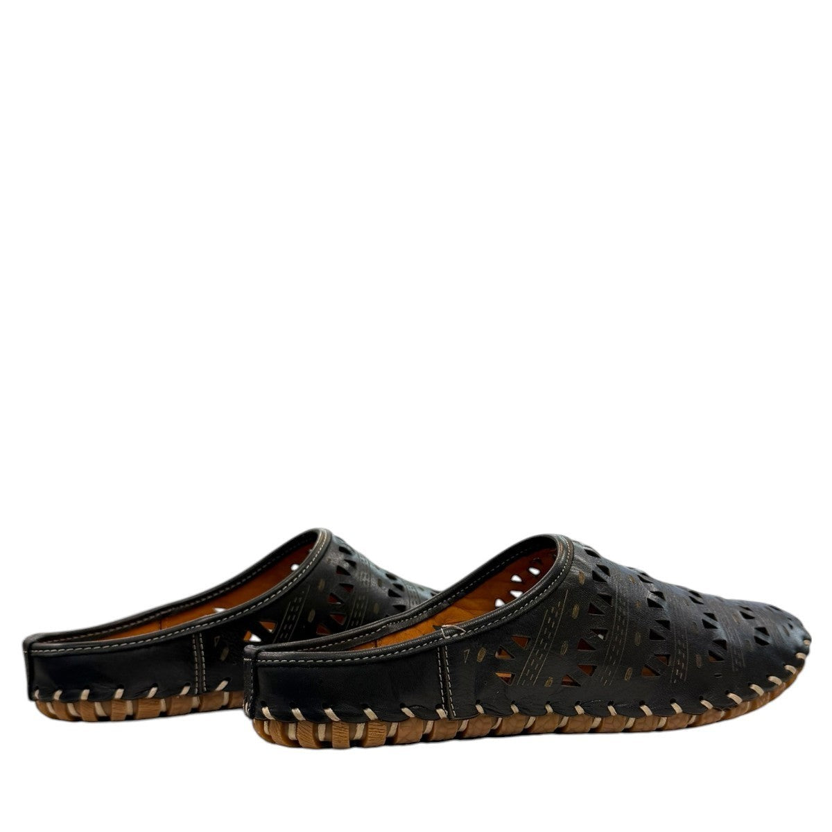 Roamers black leather slip-on mules with perforated cutouts and contrast stitching on a rubber sole.
photo of the back side