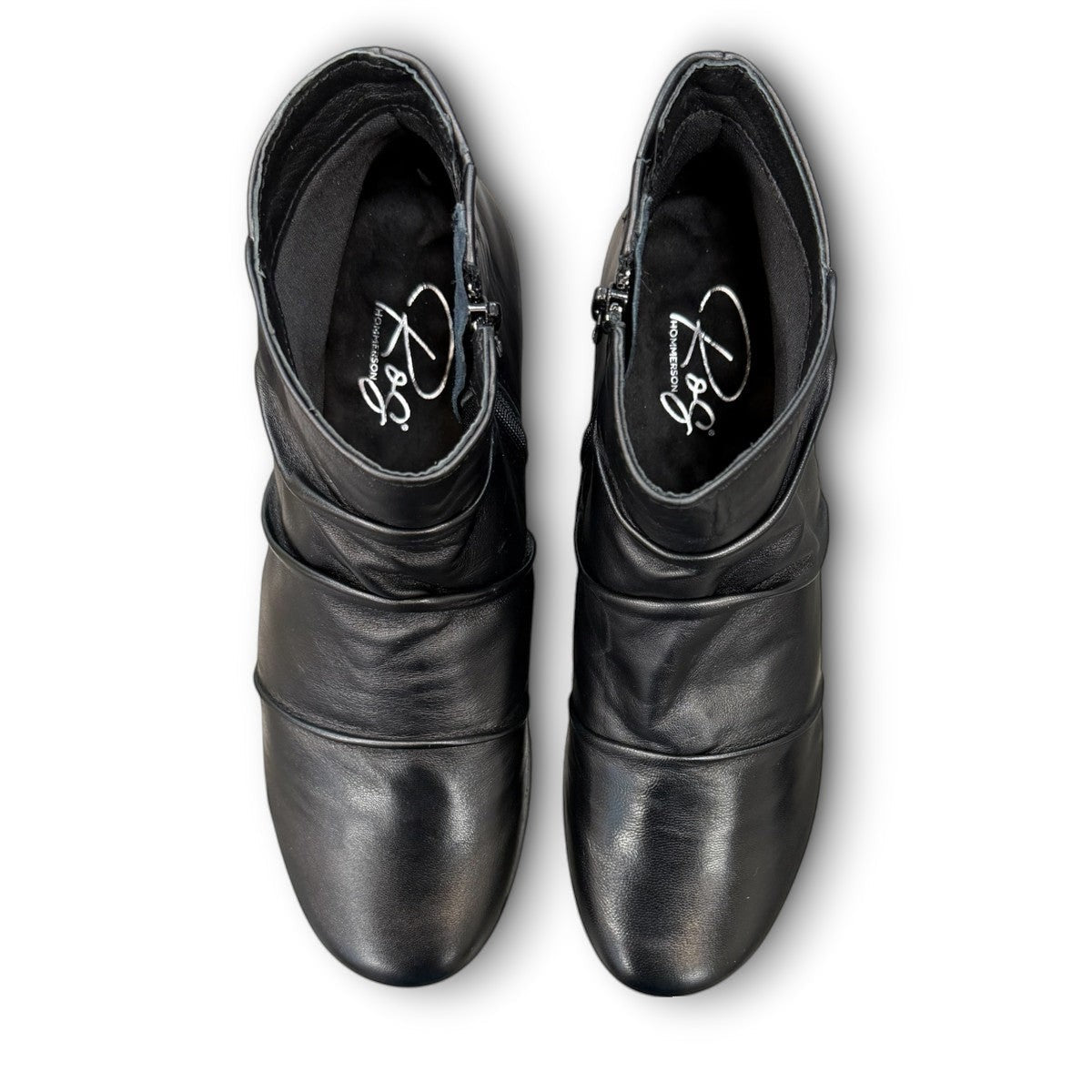 Ros Hommerson Esme black leather ankle bootie with ruched vamp detailing and a low stacked heel.
photo of the top side