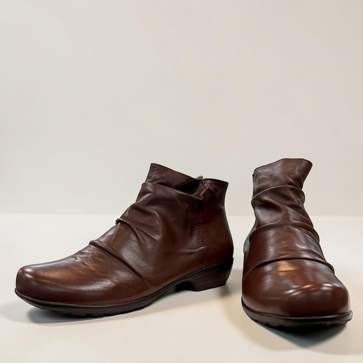 Ros Hommerson Esme brown leather ankle bootie with ruched vamp detailing and a low stacked heel.
photo of the front side