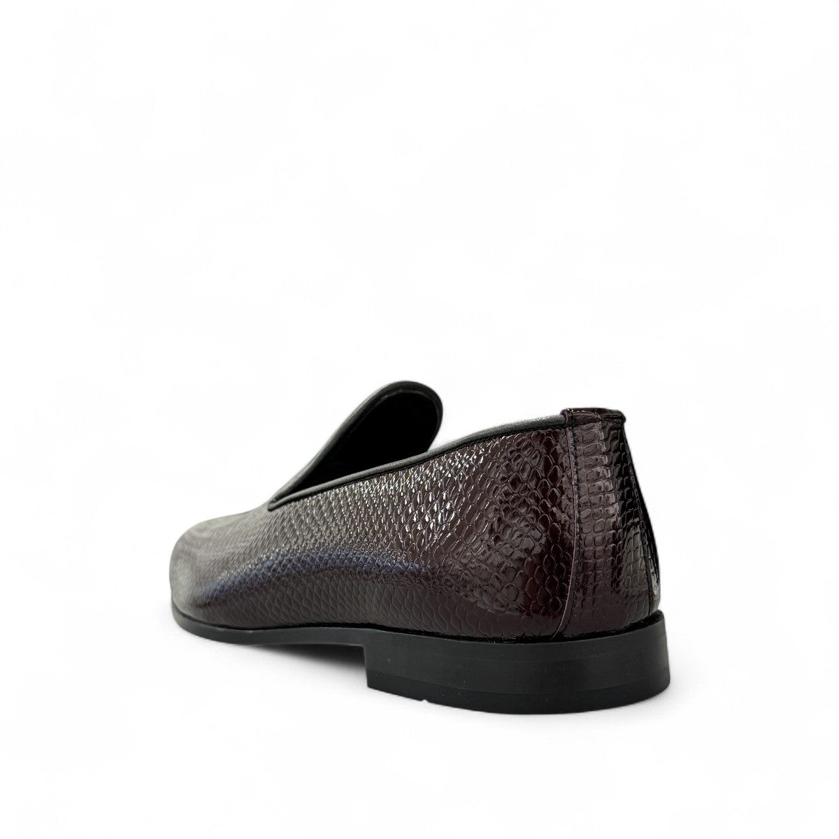 Sun Adriyan maroon patent leather loafers with a textured finish and durable rubber outsole. Photo of back view from a side angle.