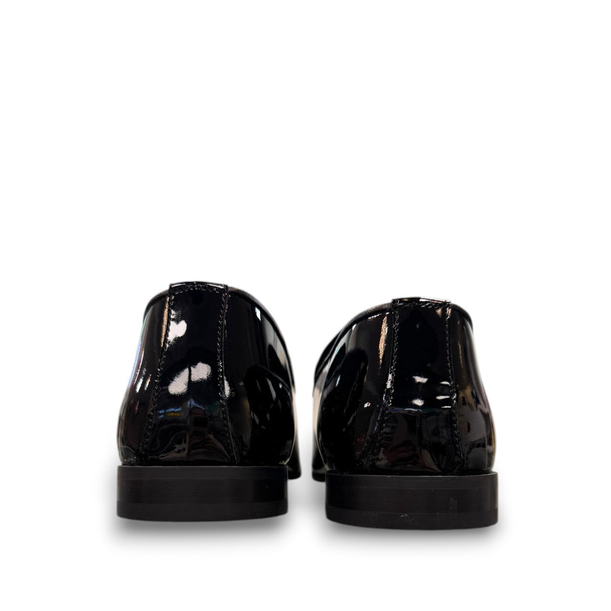 Sun Aron black patent leather loafer with handmade stitching and a durable rubber outsole. Photo of back view.