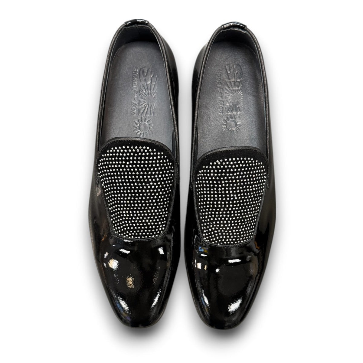 Sun Aron black patent leather loafer with handmade stitching and a durable rubber outsole. Photo of upper view.