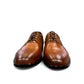 Sun Masiha brown leather lace-up dress shoe with brogue detailing and a durable rubber outsole. Photo of front view.