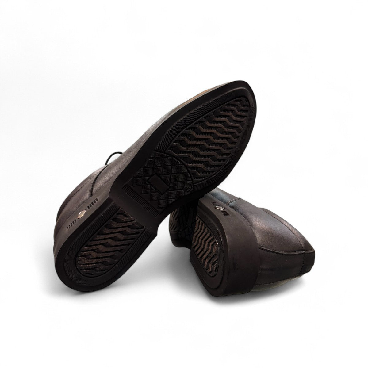 Sun Pourya black leather lace-up dress shoe with a durable rubber outsole and textured toe detail. Photo of bottom view.