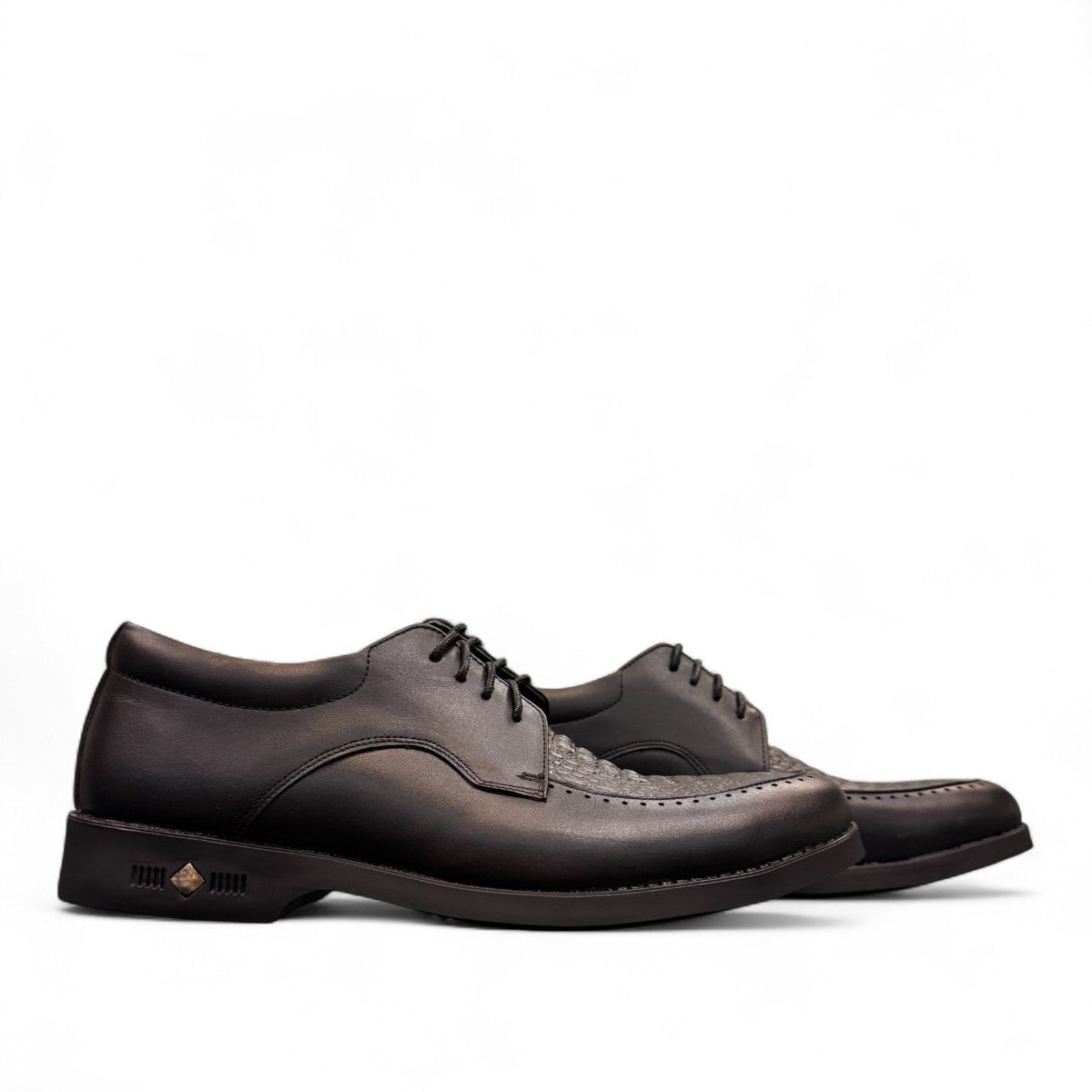 Sun Pourya black leather lace-up dress shoe with a durable rubber outsole and textured toe detail. Photo of side views.