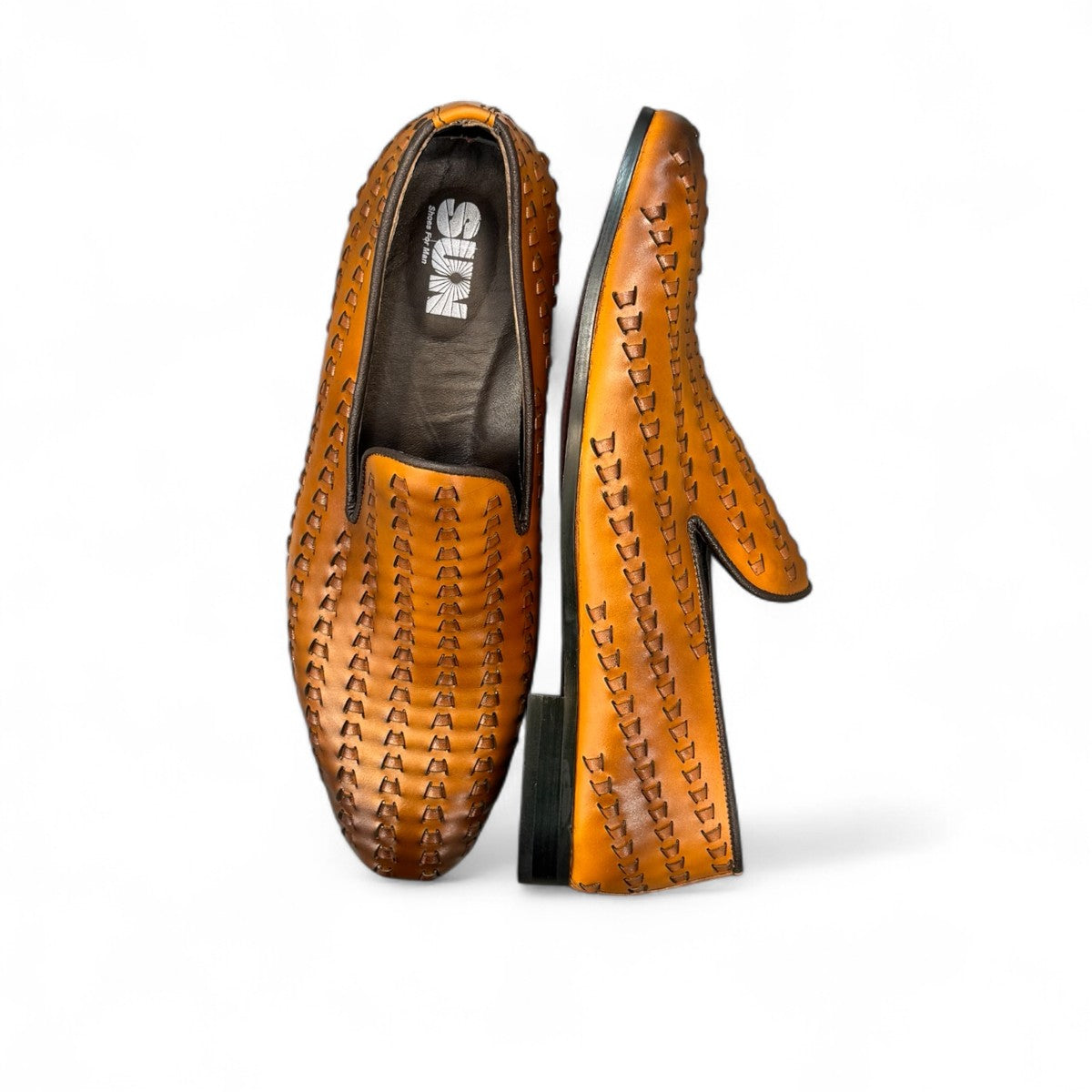 Sun Roniya brown leather loafers featuring intricate handmade stitching and a durable rubber outsole. Photo of sole.