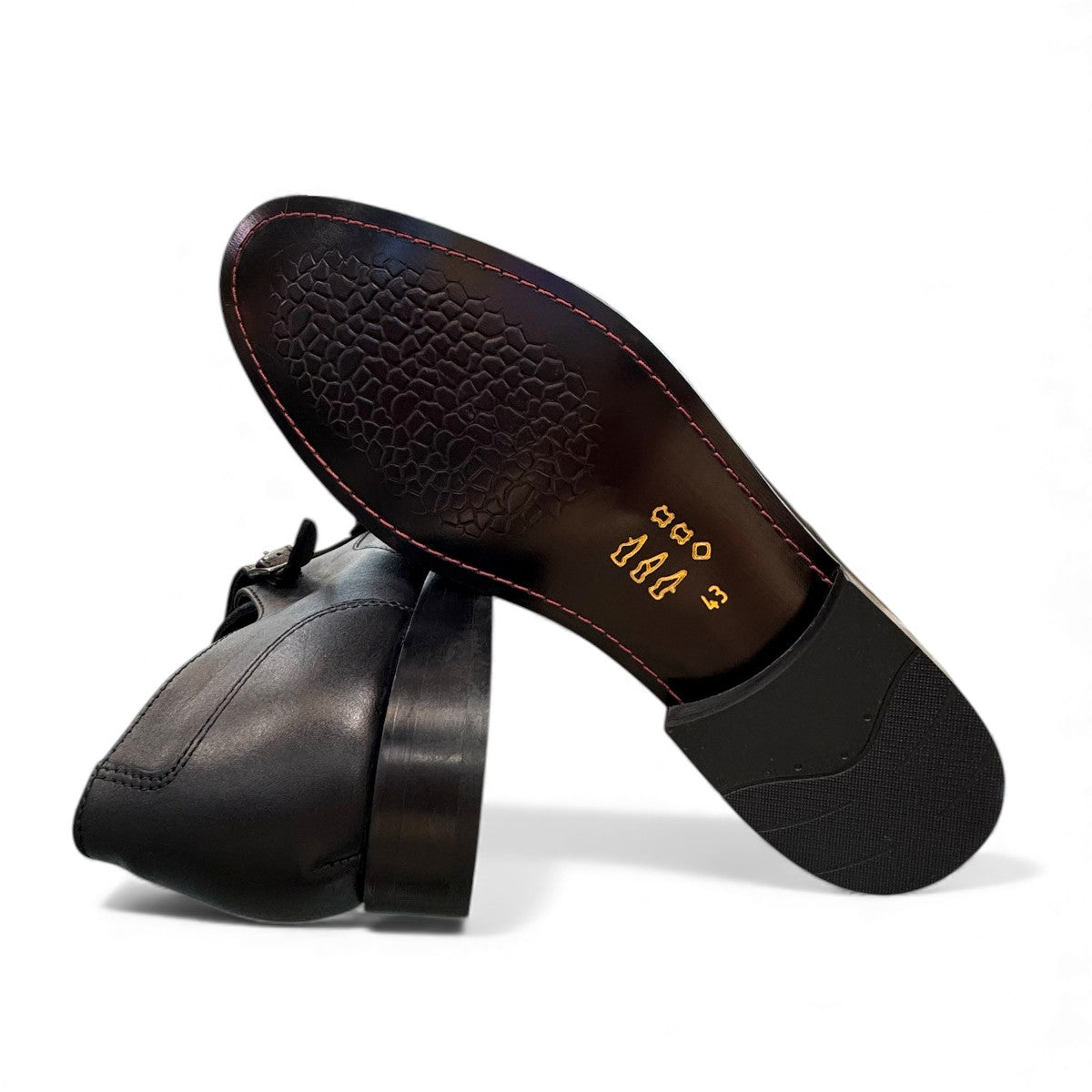 Sun Sahra black leather double monk strap shoes with handmade stitching and durable rubber outsole. Photo of bottom view.