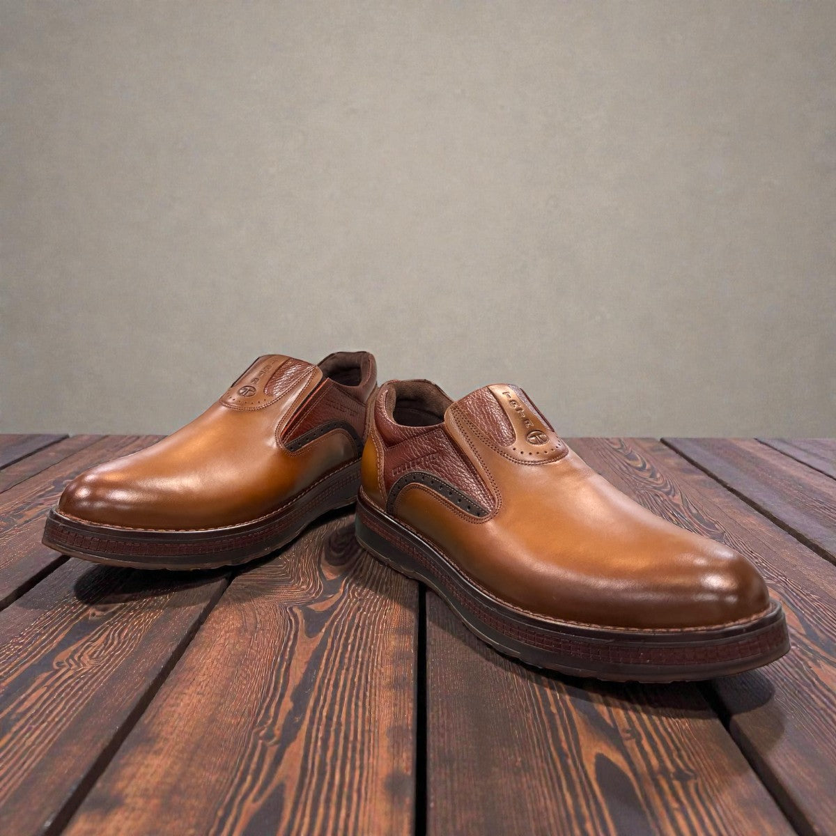 TATA brown leather slip-on shoes with handmade stitching and durable rubber outsole for formal wear.