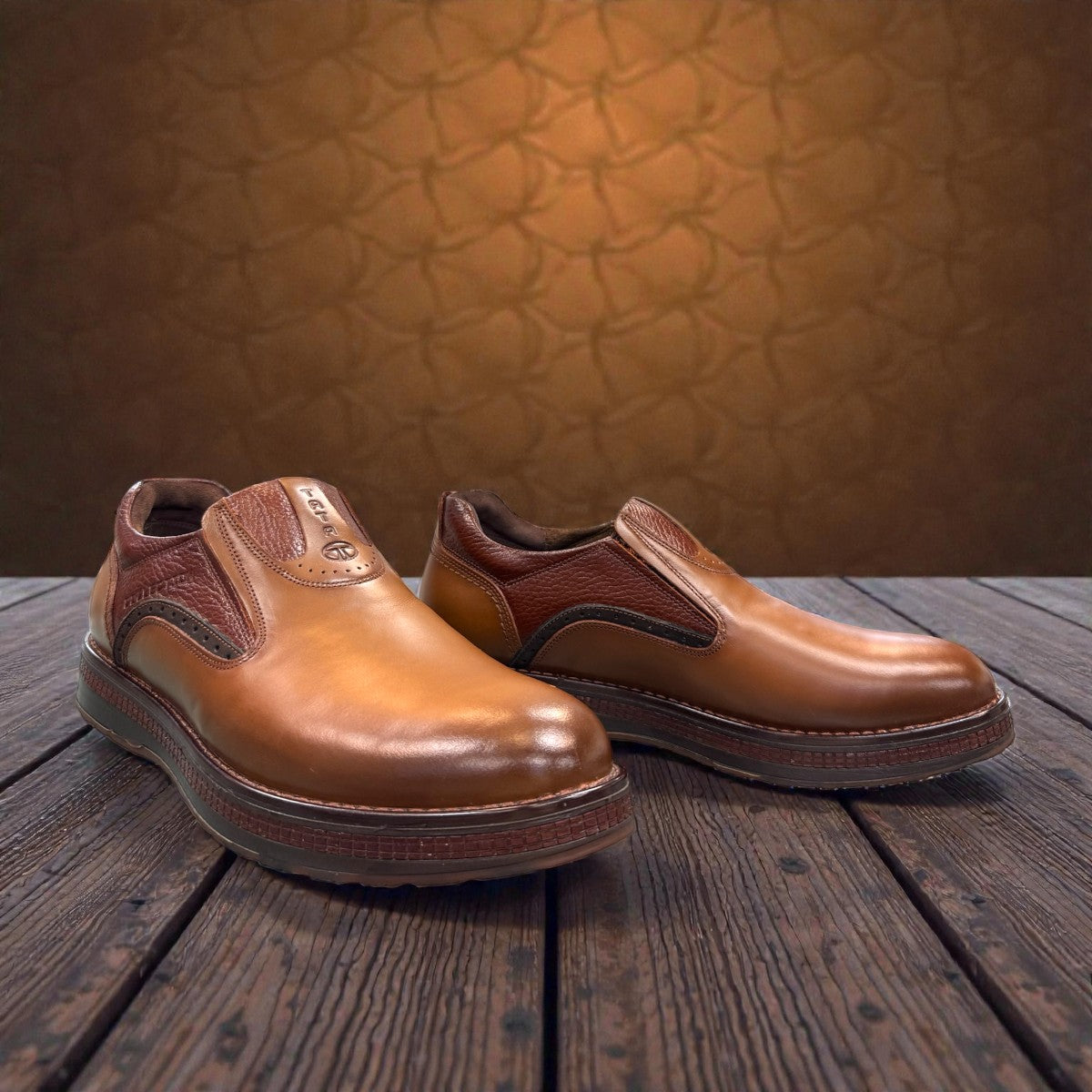 TATA brown leather slip-on shoes with handmade stitching and durable rubber outsole for formal wear.