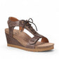 Taos Tie Wish espresso brown leather wedge sandal with T-strap, lace-up detail, and cork-style midsole. Photo of front view.