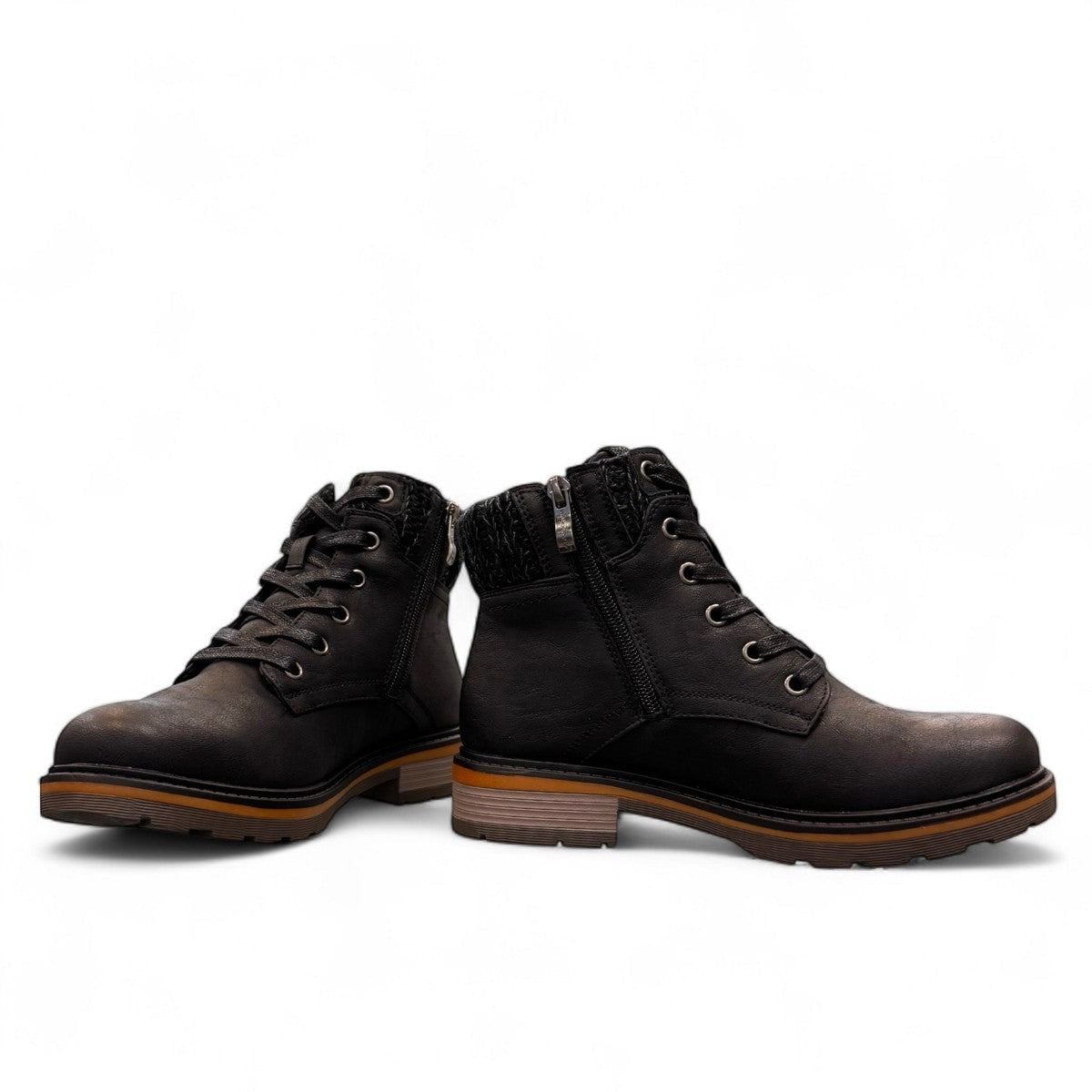 Wanderlust black ankle boot with faux leather, chunky knit cuff, side zipper, and lugged sole for winter comfort.
