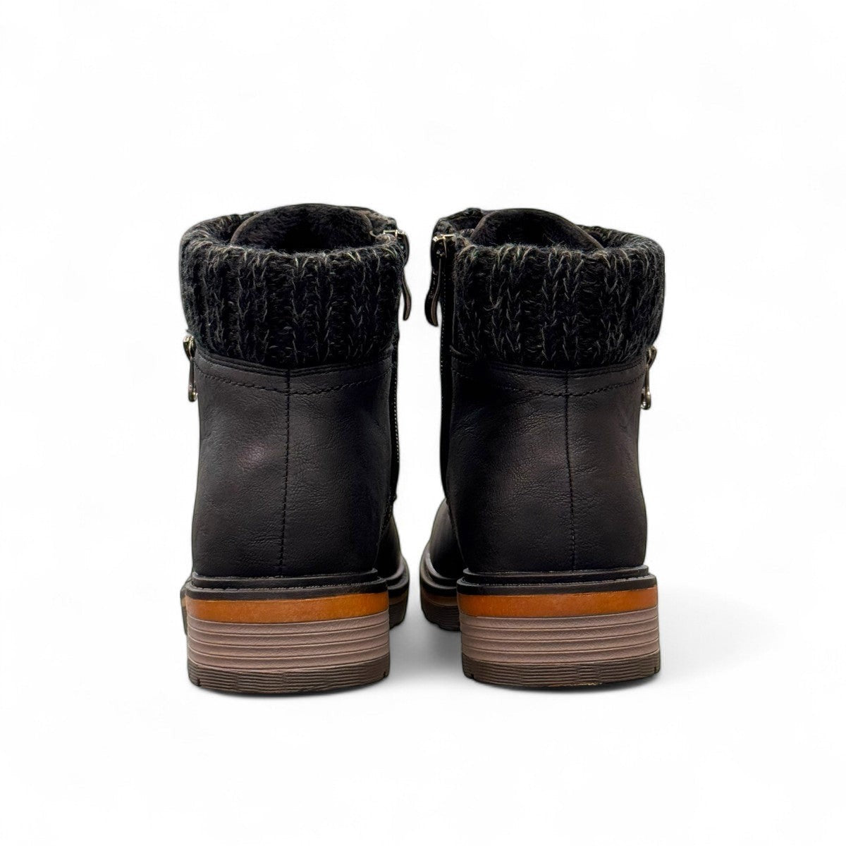 Wanderlust black ankle boot with faux leather, chunky knit cuff, side zipper, and lugged sole for winter comfort.