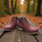 Wanderlust  burgundy faux leather ankle boot with a chunky knit cuff, side zipper, lace-up front, and lugged sole.