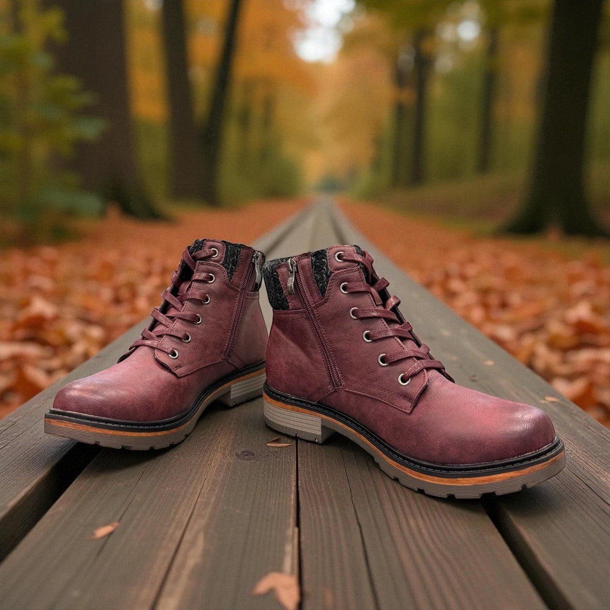 Wanderlust  burgundy faux leather ankle boot with a chunky knit cuff, side zipper, lace-up front, and lugged sole.