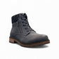 Wanderlust navy ankle boot with faux leather, chunky knit cuff, side zipper, lace-up closure, and lugged sole.