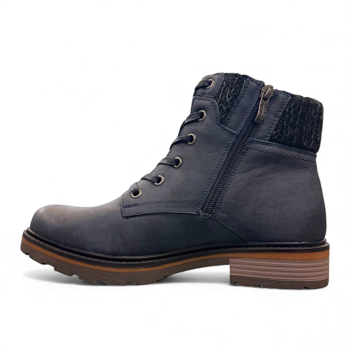 Wanderlust navy ankle boot with faux leather, chunky knit cuff, side zipper, lace-up closure, and lugged sole.