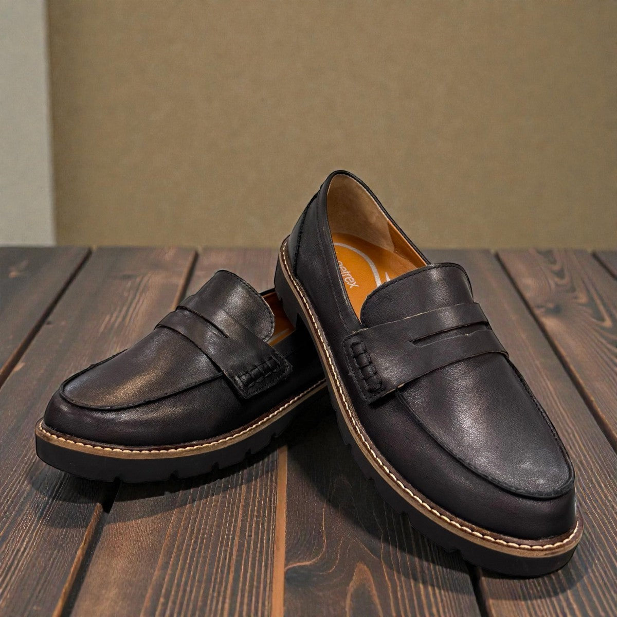 Aetrex Collette black leather loafer showing the durable, lightweight treaded outsole and heel.