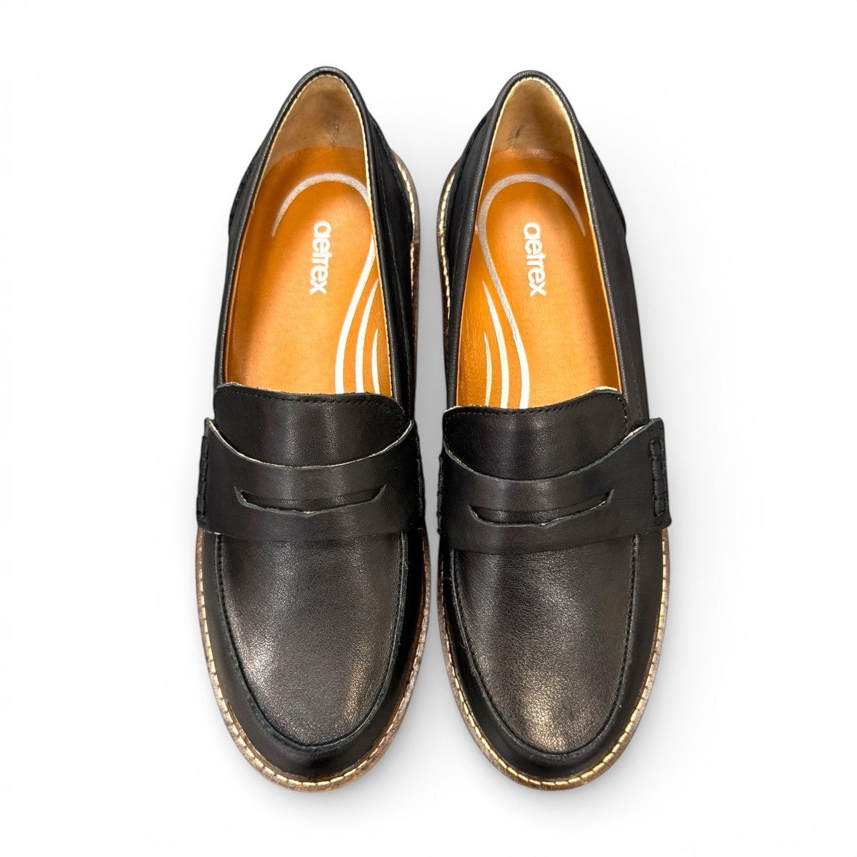 Aetrex Collette black leather loafer showing the durable, lightweight treaded outsole and heel.