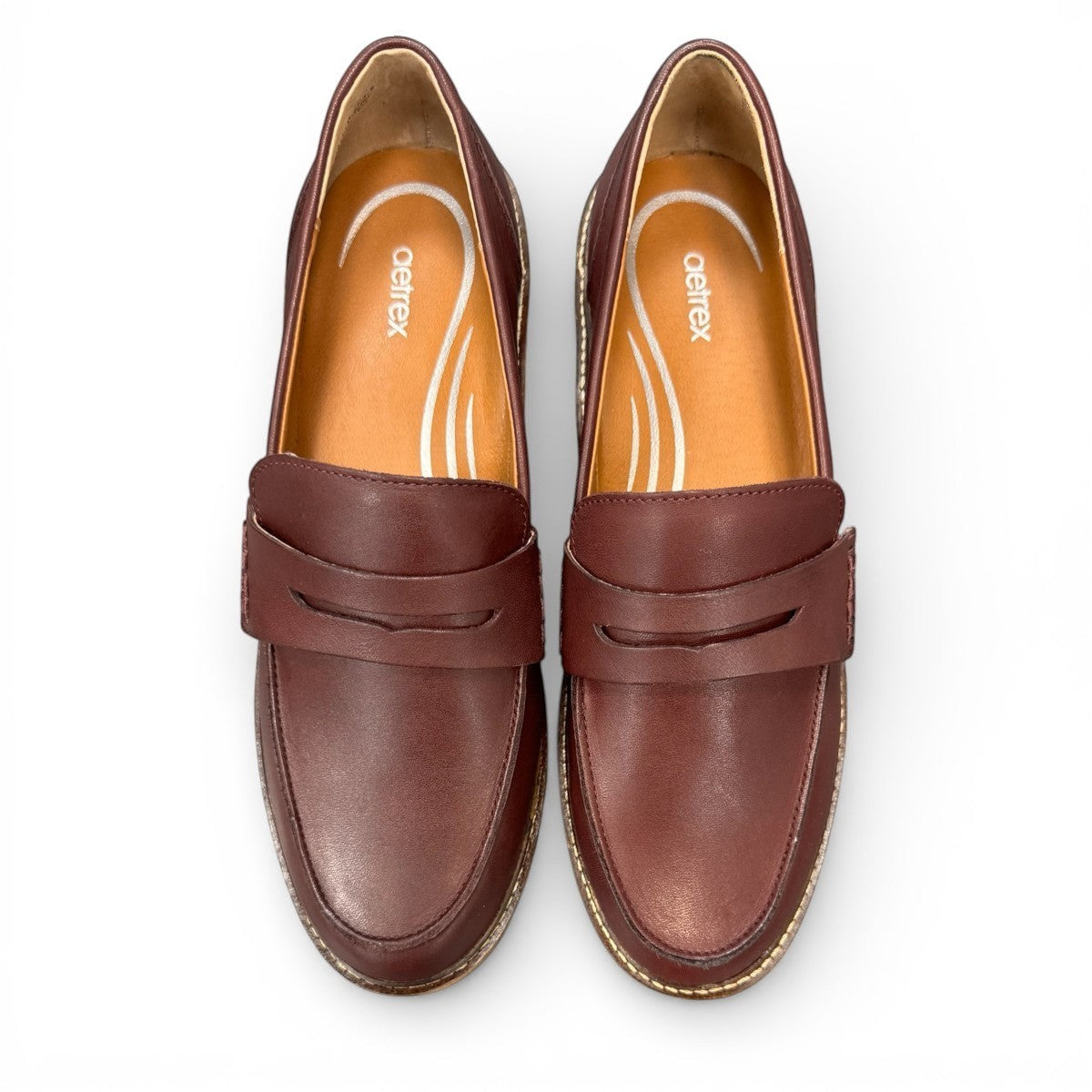 Aetrex Collette burgundy leather loafer showing the durable black lugged outsole and low heel profile.