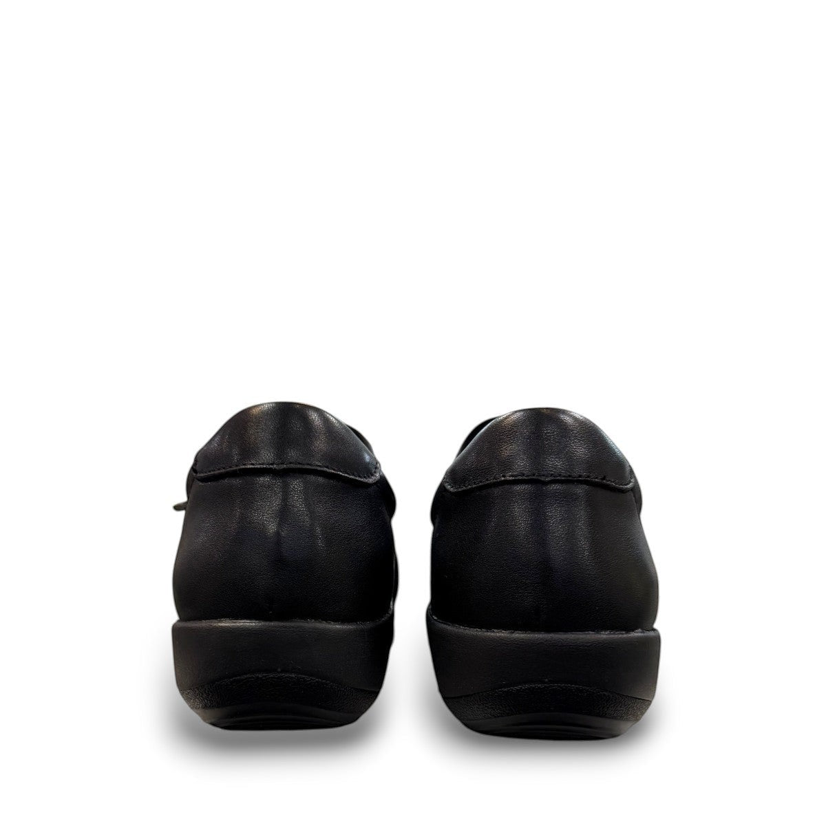 Aetrex Katie black leather casual shoe showing the durable rubber outsole and side zipper detail