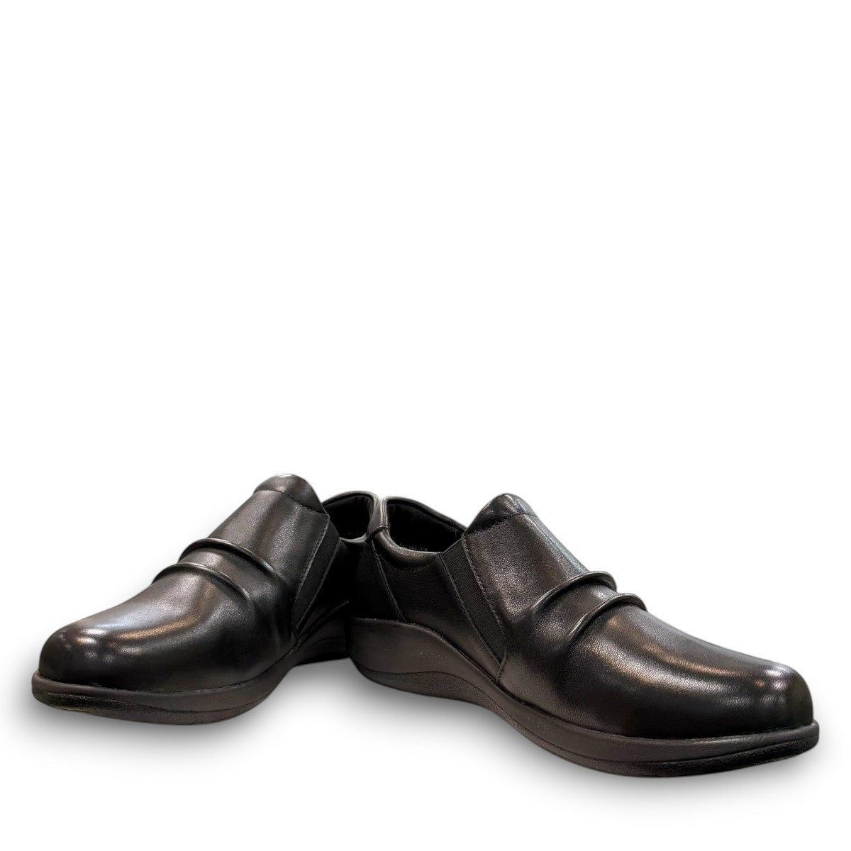 Aetrex Katie black leather casual shoe showing the durable rubber outsole and side zipper detail