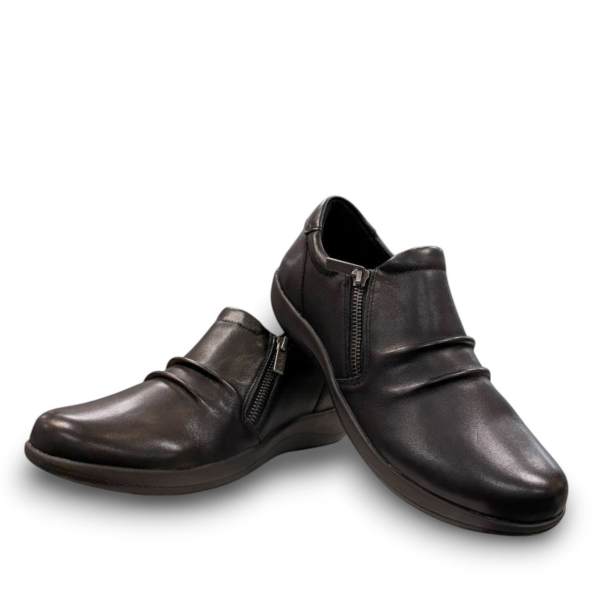 Aetrex Katie black leather casual shoe showing the durable rubber outsole and side zipper detail