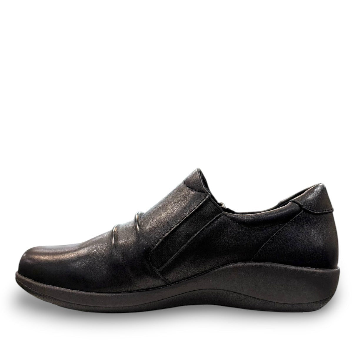 Aetrex Katie black leather casual shoe showing the durable rubber outsole and side zipper detail