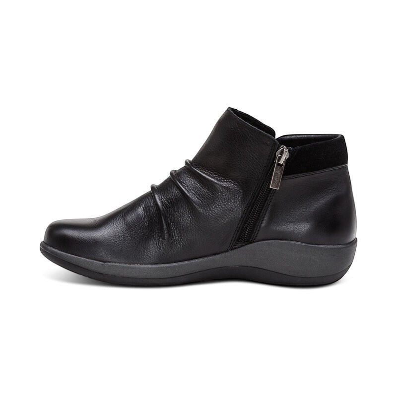 Aetrex Luna black leather ankle boots with pleated detail, side zipper, and adjustable buckle.