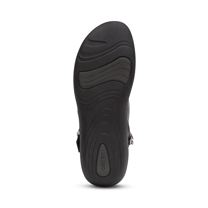 Aetrex Luna black leather ankle boots with pleated detail, side zipper, and adjustable buckle.