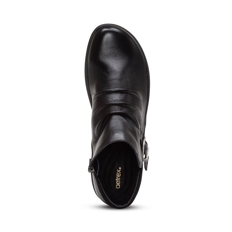 Aetrex Luna black leather ankle boots with pleated detail, side zipper, and adjustable buckle.
