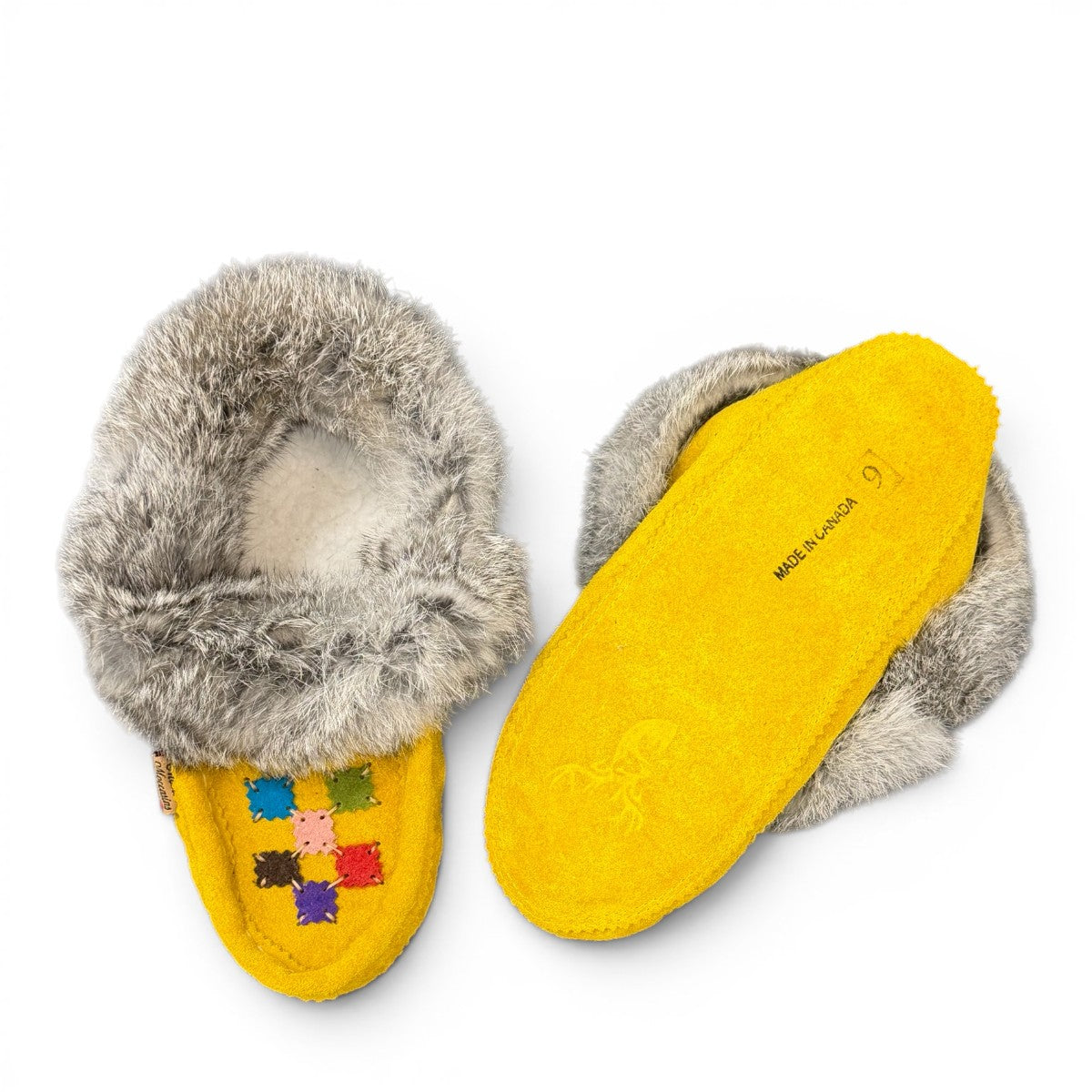 alberta-suede-moccasins yellow cowhide suede moccasins with a soft rabbit fur ankle collar, handcrafted for cozy comfort.
photo of the bottom side