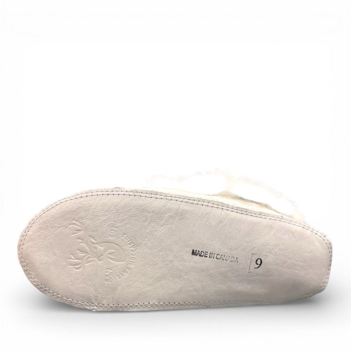 Alberta  white leather moccasins featuring a plush fur collar and side brand tag, side view.
photo of the bottom side