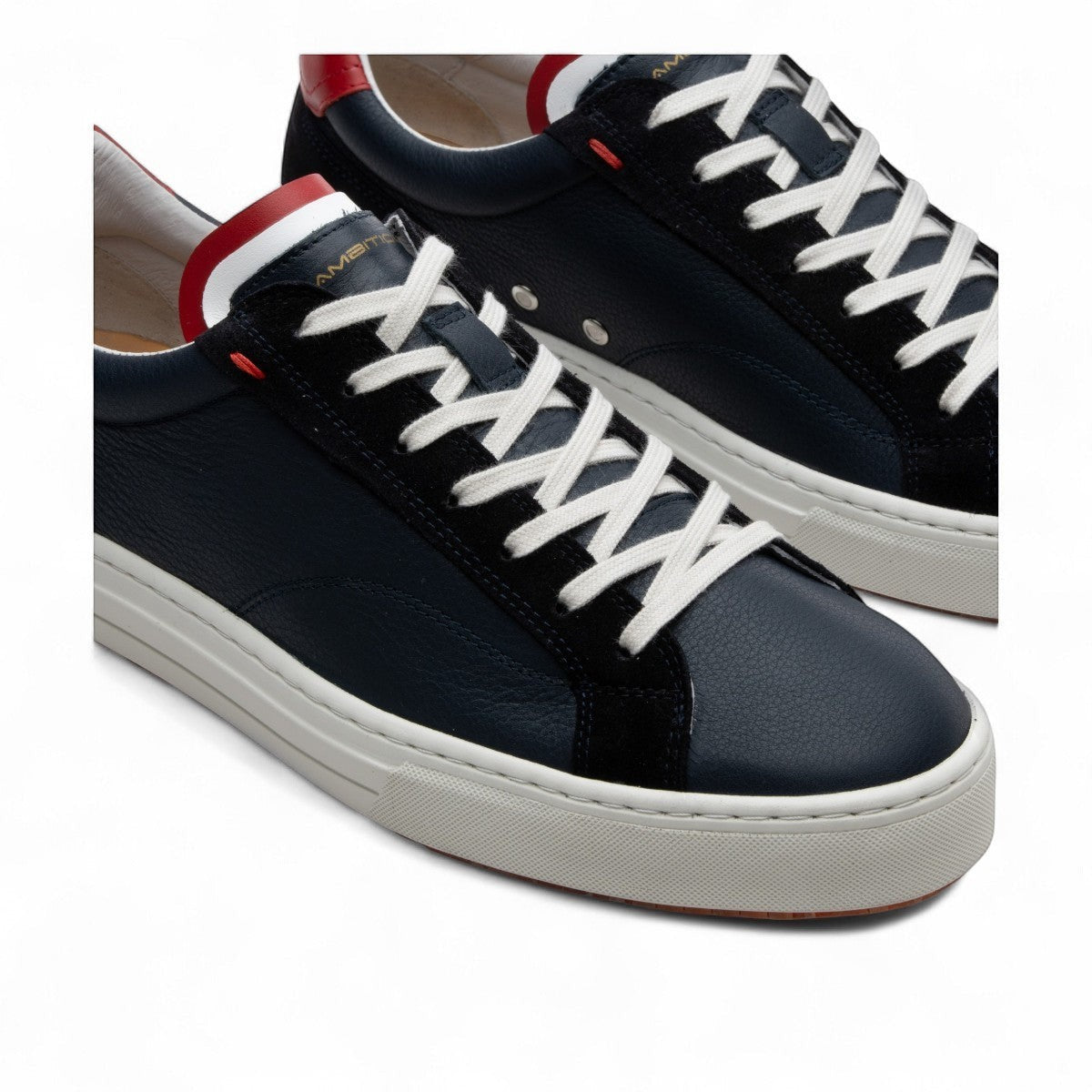 AMBITIOUS navy leather lace-up sneakers with white and red accents and a lightweight transparent sole
