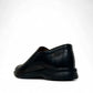 Atropat Aghdasieh black leather slip-on dress shoe with handmade stitching and rubber outsole. Photo of side view from the back.