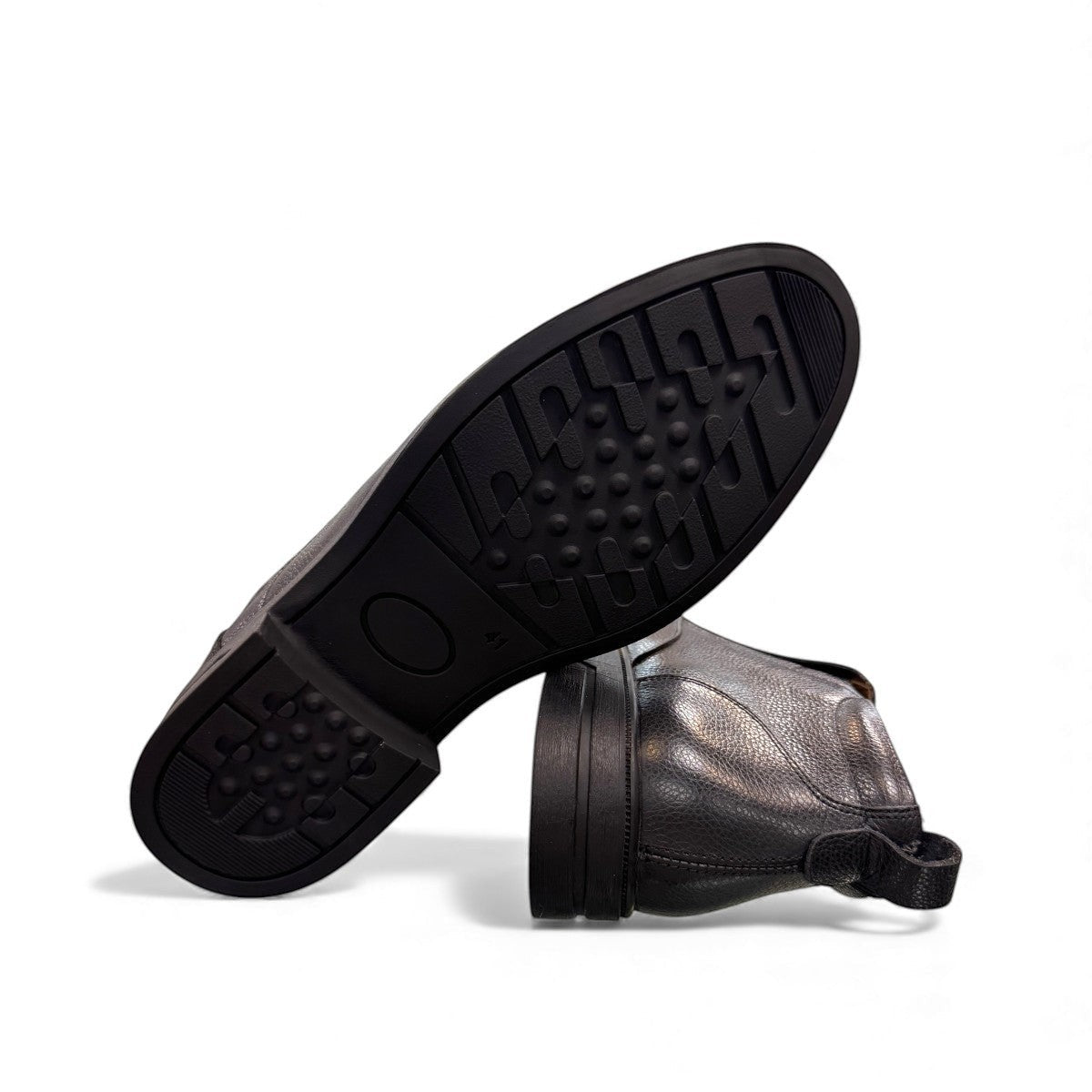 Atropat Amin black leather boots with textured upper, rubber outsole, and subtle handmade stitching. Photo of bottom view.