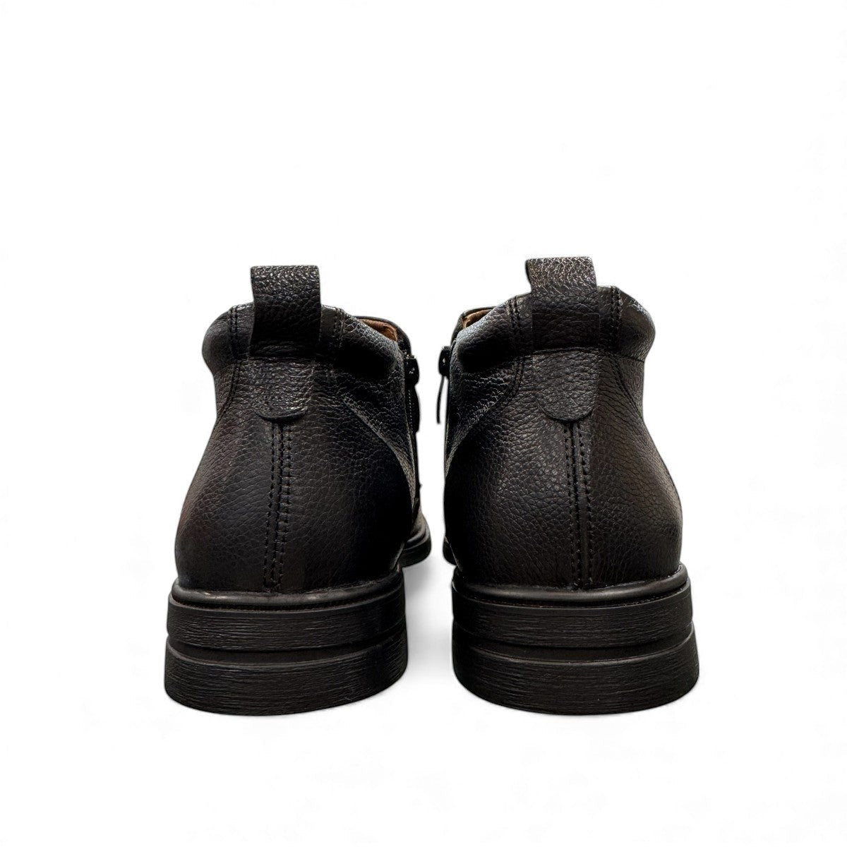 Atropat Amin black leather boots with textured upper, rubber outsole, and subtle handmade stitching. Photo of back view.