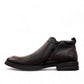 Atropat Amin black leather boots with textured upper, rubber outsole, and subtle handmade stitching. Photo of inside side view.