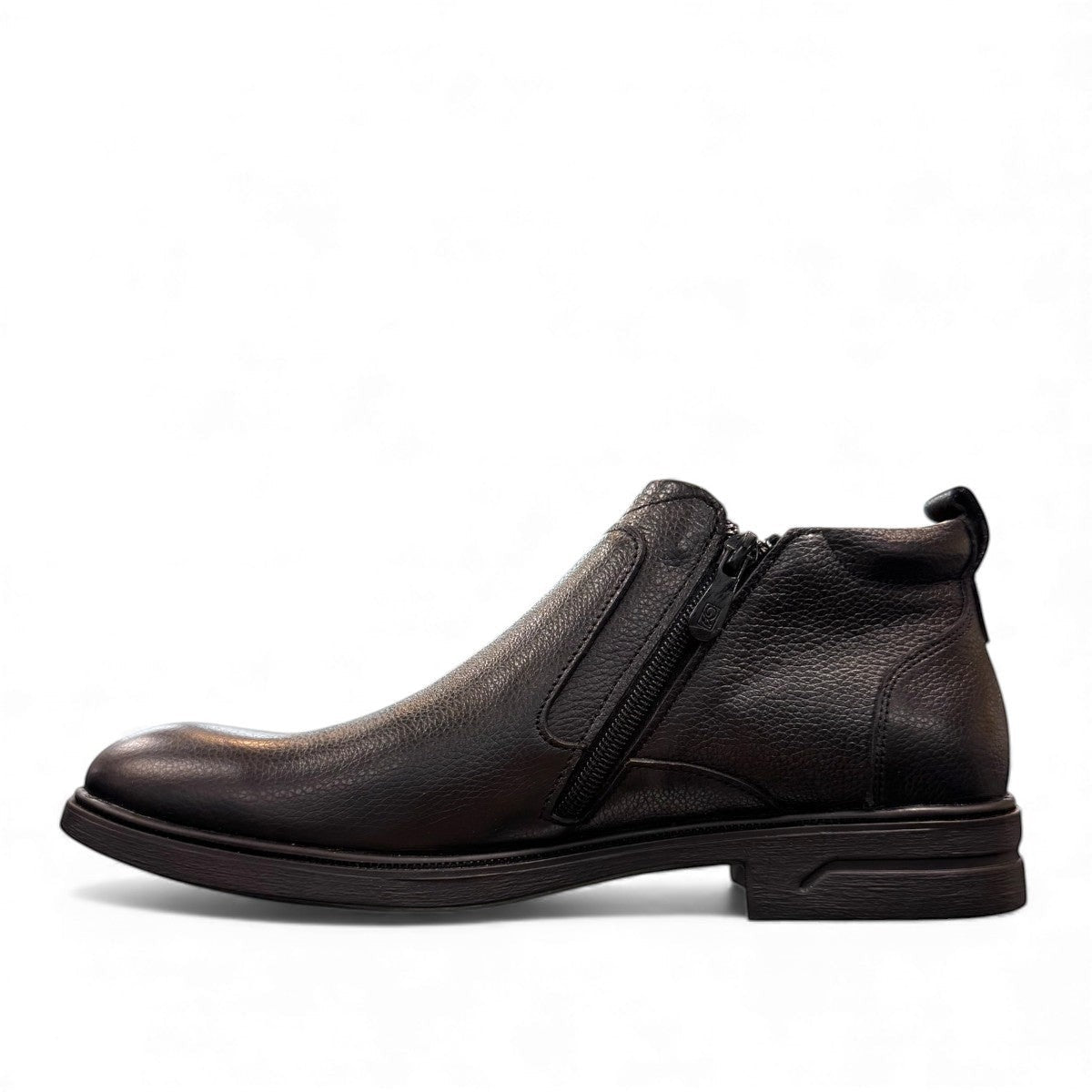Atropat Amin black leather boots with textured upper, rubber outsole, and subtle handmade stitching. Photo of inside side view.